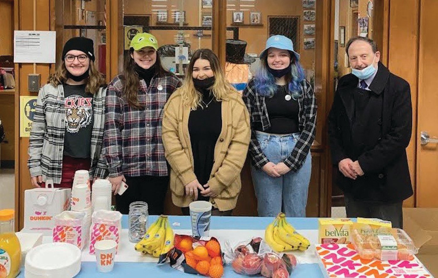 SUPER SPECIAL SERVERS: Dr. Bernard DiLullo, Superintendent of Schools in Johnston, was on hand to show support for last Friday’s JHS Music Department Crazy Hat Day that featured coffee, juice and pastry items served by students Maya Ferreira, Mackenzie Hanna, Destinee Costa and Trinity Biondi.